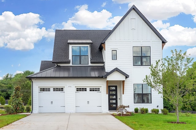 view of front of home with a garage and a front lawn