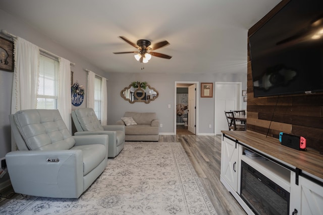 living room featuring ceiling fan and light wood-type flooring