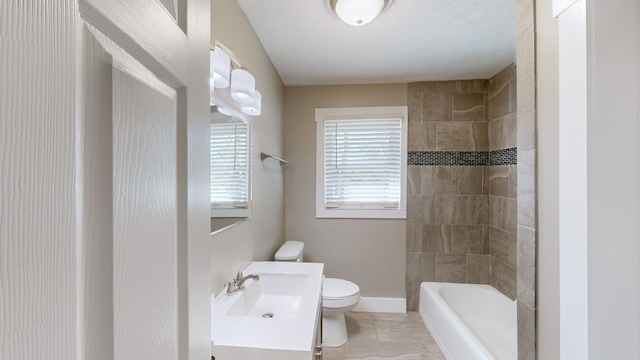 full bathroom featuring vanity, tiled shower / bath combo, and toilet