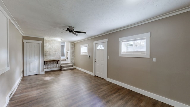 unfurnished living room featuring ornamental molding, a textured ceiling, and hardwood / wood-style flooring