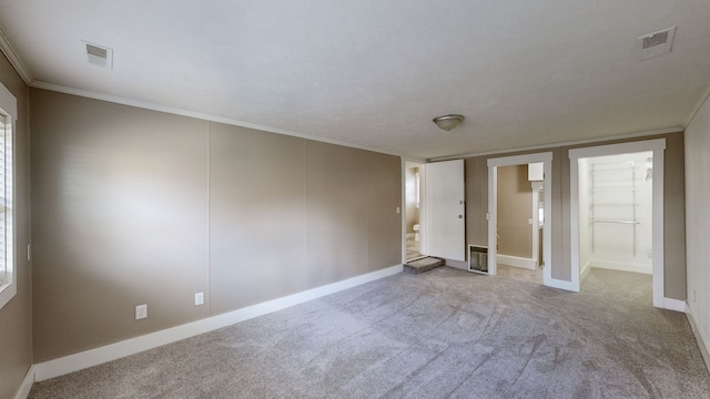 unfurnished bedroom featuring light colored carpet and ornamental molding