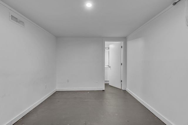 spare room featuring crown molding and concrete floors