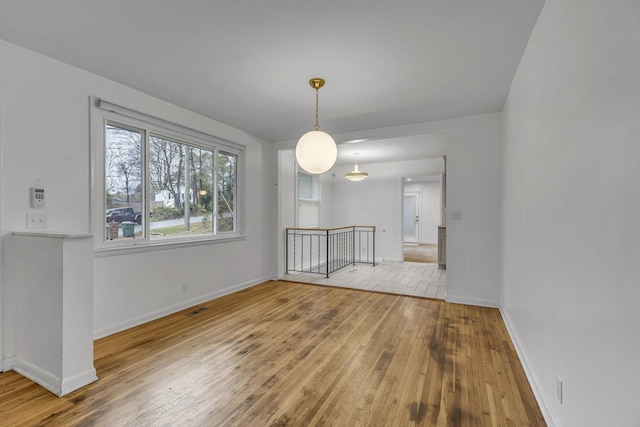 unfurnished dining area with light wood-type flooring