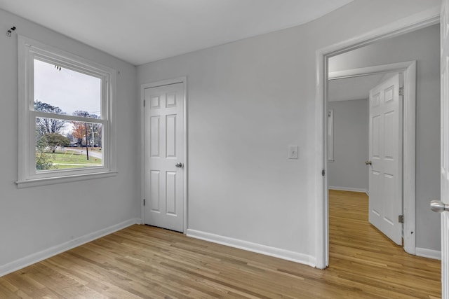 unfurnished bedroom featuring a closet and light hardwood / wood-style flooring