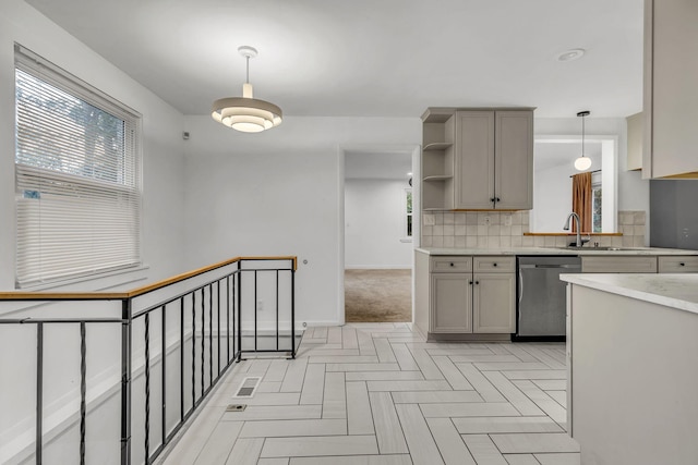 kitchen with gray cabinets, dishwasher, pendant lighting, and sink