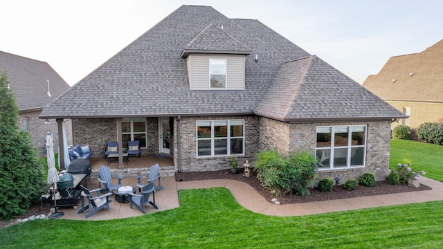 back of property featuring a lawn, a patio, and an outdoor hangout area