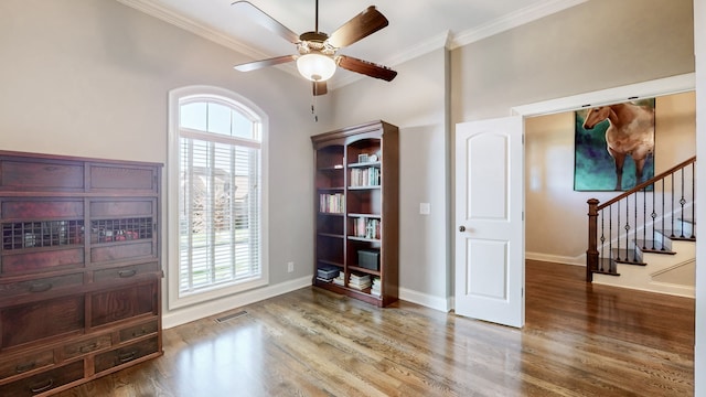 interior space with crown molding, ceiling fan, and hardwood / wood-style flooring