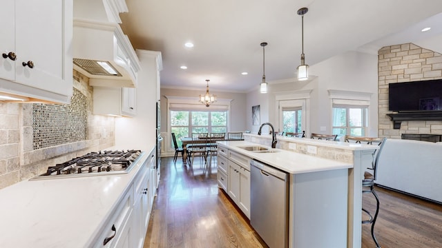 kitchen with white cabinets, a wealth of natural light, sink, and appliances with stainless steel finishes