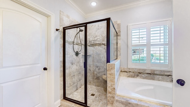 bathroom featuring separate shower and tub and crown molding