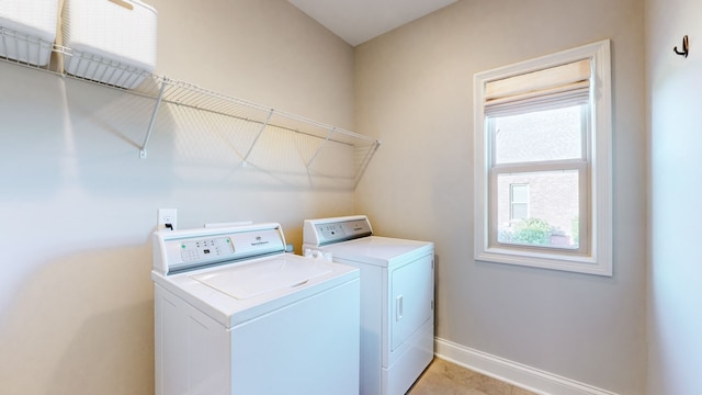 washroom featuring light tile patterned flooring and washing machine and clothes dryer