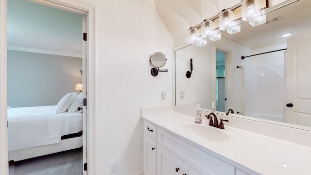 bathroom with a shower, vanity, and ornamental molding