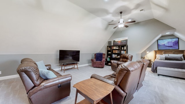 carpeted living room with ceiling fan and vaulted ceiling