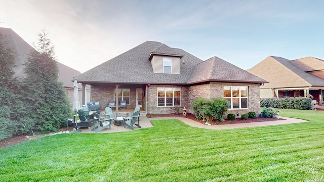 rear view of house with an outdoor living space, a yard, and a patio