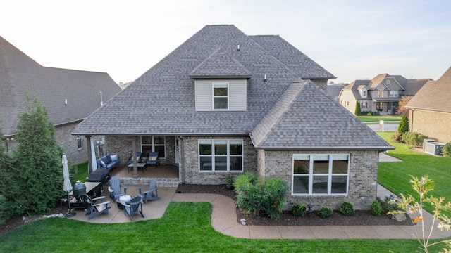 back of property featuring a patio area and a yard