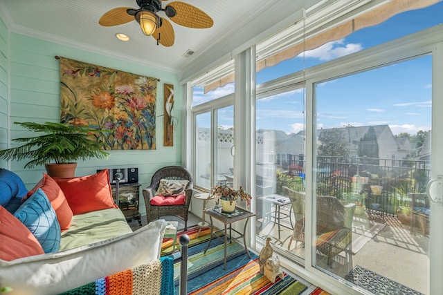 sunroom / solarium featuring ceiling fan