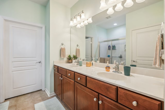 bathroom with tile patterned flooring, vanity, and a shower with shower door