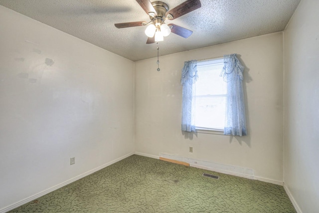 carpeted empty room with ceiling fan and a textured ceiling