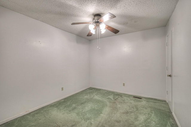 carpeted empty room featuring a textured ceiling