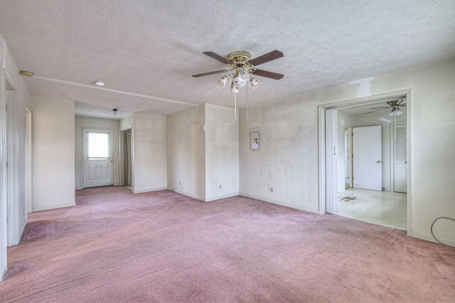 empty room with light carpet and a textured ceiling