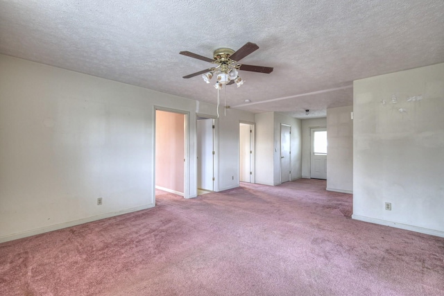 unfurnished room featuring a textured ceiling, light colored carpet, and ceiling fan