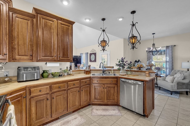 kitchen featuring dishwasher, an inviting chandelier, sink, hanging light fixtures, and light tile patterned floors