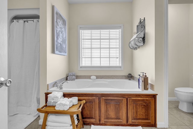 bathroom featuring tile patterned flooring, shower with separate bathtub, and toilet