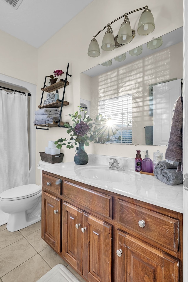 bathroom featuring tile patterned floors, vanity, and toilet