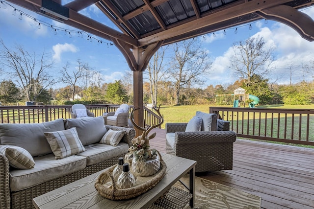 deck with a playground, an outdoor living space, and a lawn