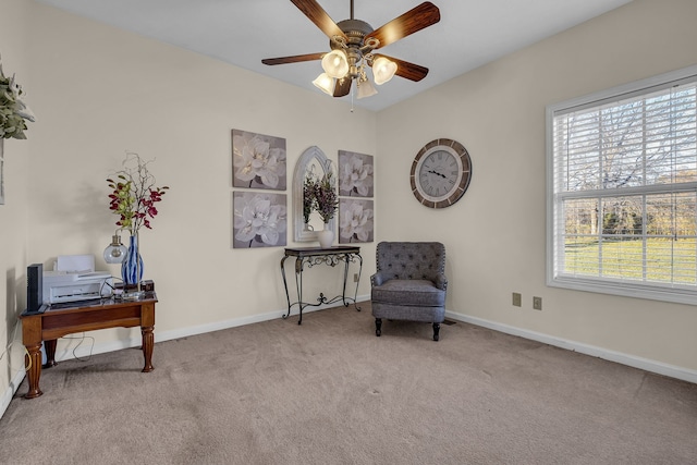 sitting room featuring ceiling fan and light colored carpet