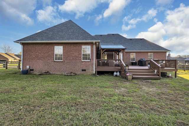 back of house featuring a gazebo, a wooden deck, and a yard