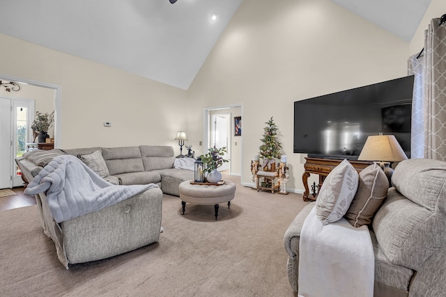 living room featuring carpet floors and high vaulted ceiling