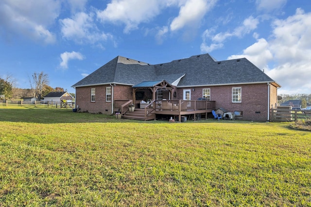 back of house with a yard and a deck