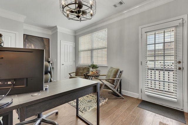 office space featuring crown molding, light hardwood / wood-style flooring, and a chandelier