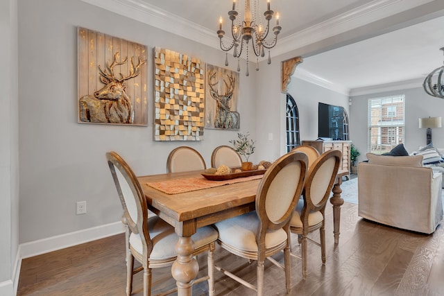 dining area with hardwood / wood-style flooring, an inviting chandelier, and crown molding