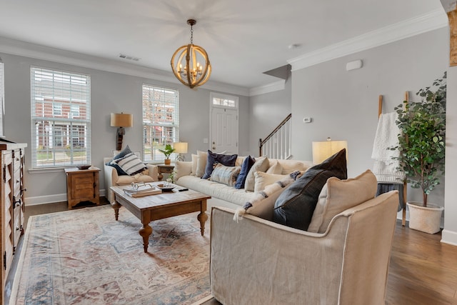 living room with crown molding, an inviting chandelier, and hardwood / wood-style flooring