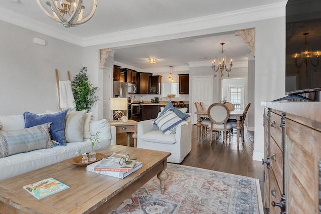 living room with a chandelier, dark wood-type flooring, and ornamental molding