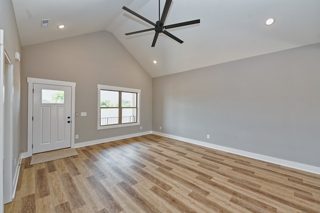 interior space featuring light hardwood / wood-style floors, high vaulted ceiling, and ceiling fan