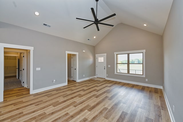 interior space with light hardwood / wood-style floors, high vaulted ceiling, and ceiling fan