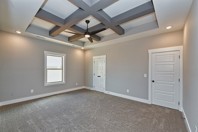 carpeted empty room featuring beam ceiling, ceiling fan, and coffered ceiling