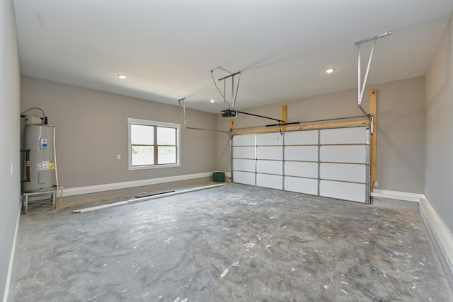 garage with electric water heater and a garage door opener