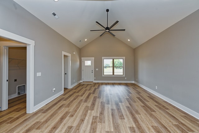 unfurnished living room with ceiling fan, light hardwood / wood-style flooring, and high vaulted ceiling