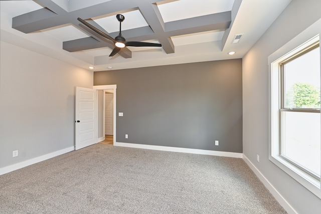 carpeted empty room with beam ceiling, ceiling fan, a healthy amount of sunlight, and coffered ceiling