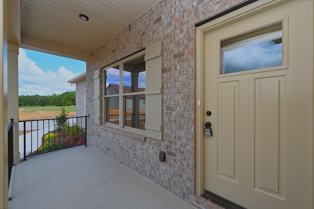 view of exterior entry with a porch