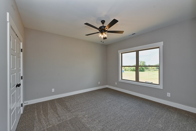 carpeted spare room with ceiling fan