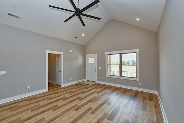 unfurnished living room featuring light wood-type flooring, high vaulted ceiling, and ceiling fan