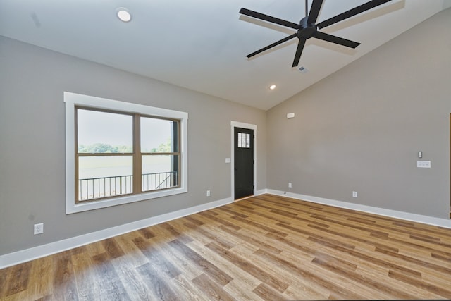 spare room with ceiling fan, light hardwood / wood-style floors, and vaulted ceiling