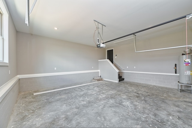 garage featuring a garage door opener and water heater