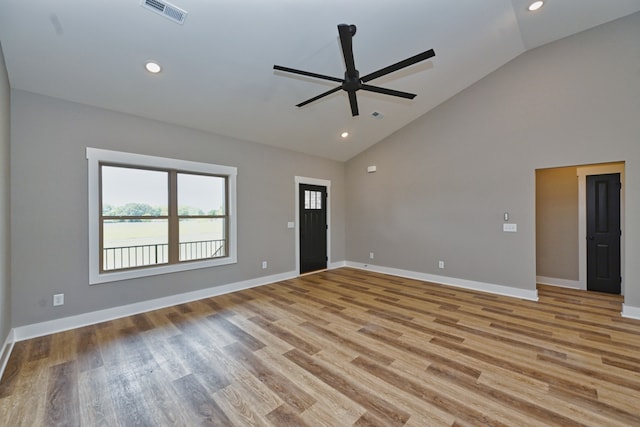 spare room with ceiling fan, light hardwood / wood-style floors, and vaulted ceiling