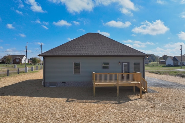 rear view of property with a wooden deck