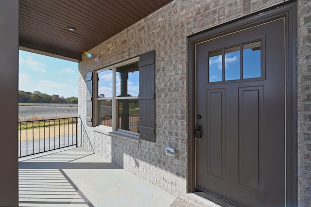 property entrance featuring a water view and a porch